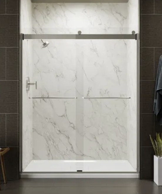 Walk-in shower with marble-look walls and chrome sliding glass doors