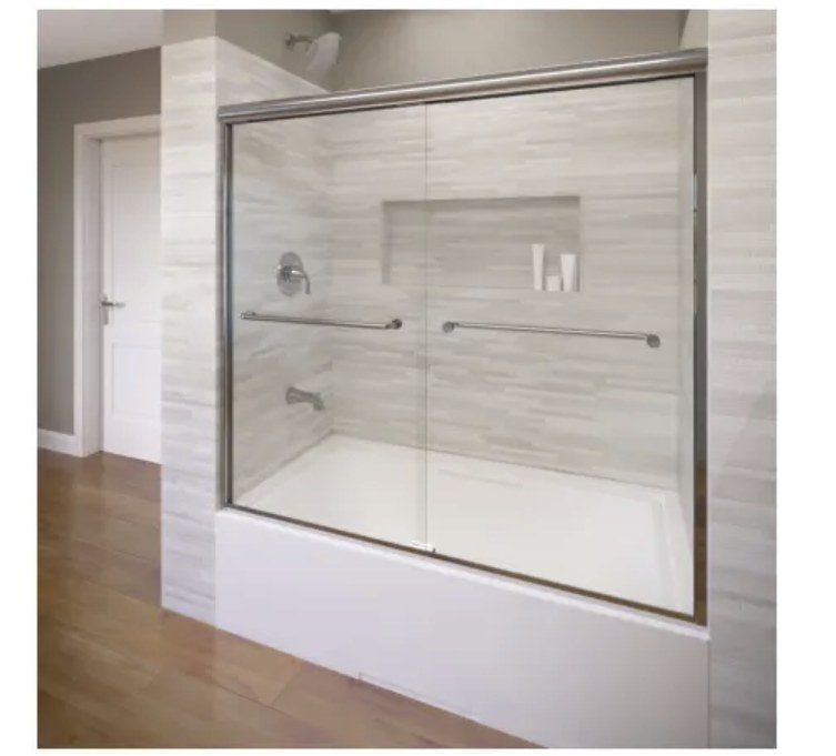 Alcove tub and shower with sliding glass doors, niche, and tile surround